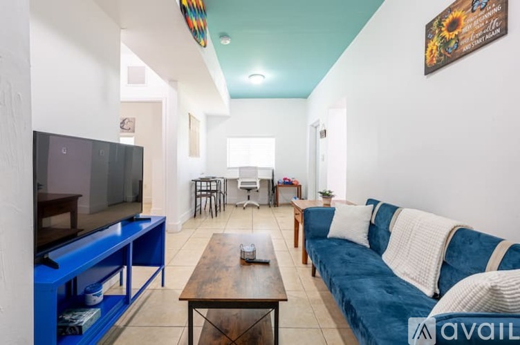 A living room with a blue couch and a television.