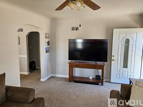 A living room with a television and a couch.