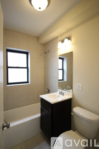 A bathroom with a sink, toilet and bathtub.