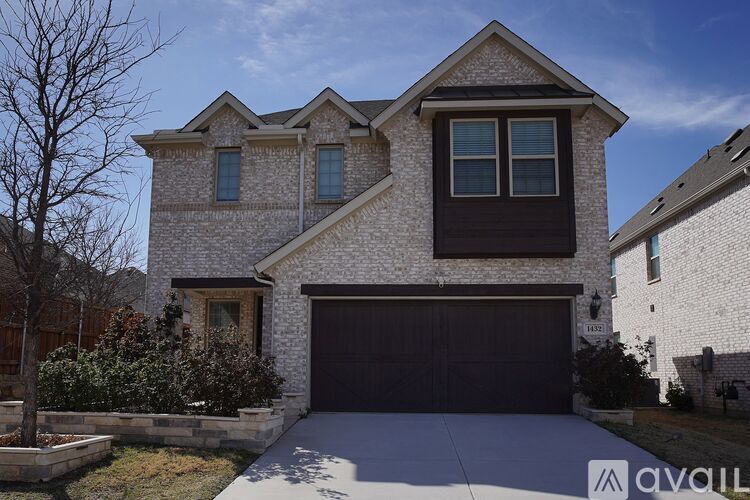 A house with a garage and a driveway in front.
