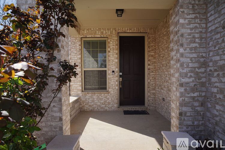 A house entrance with a brown door and a window.