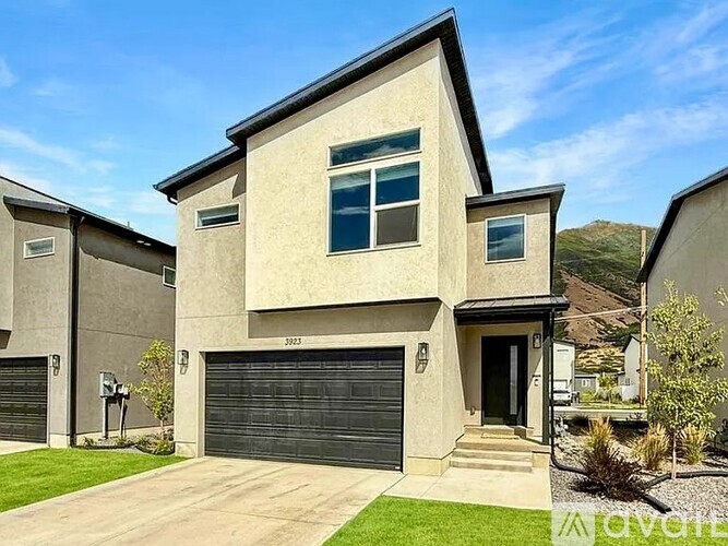 A modern house with a garage is numbered 3023.