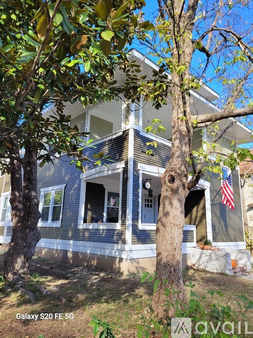 A house with a tree in front of it.