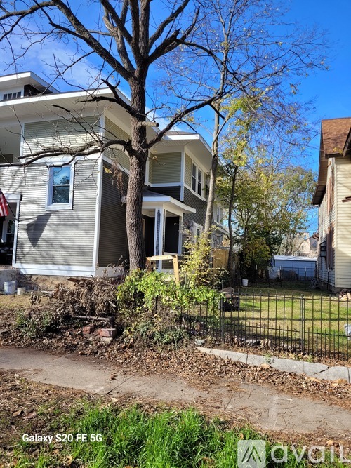 A house with a tree in front of it.