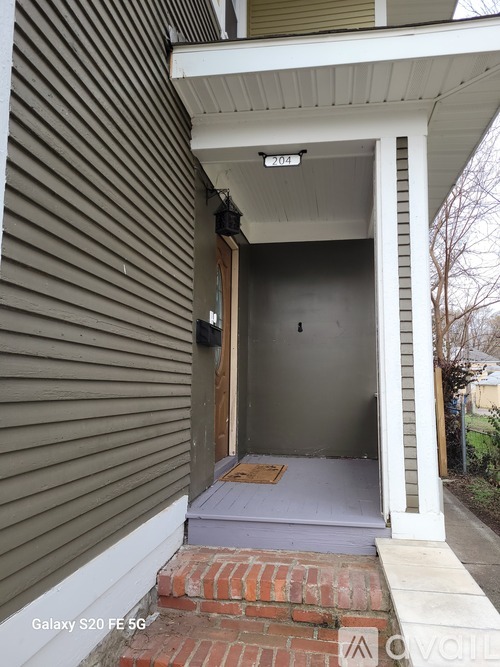 A house with a front porch and steps leading up to it.