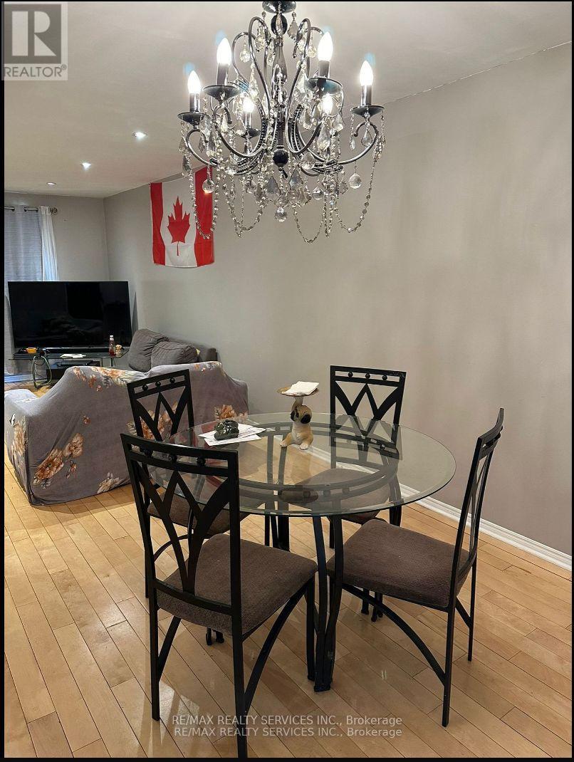 A dining room with a glass table and chairs.