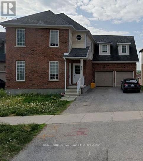 A brick house with a car parked in front.