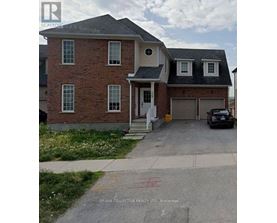A brick house with a car parked in front.