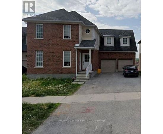 A brick house with a car parked in front.