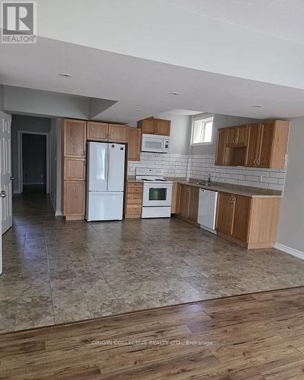 A kitchen with wooden cabinets and a tiled floor.