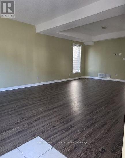 A room with wooden flooring and a window.