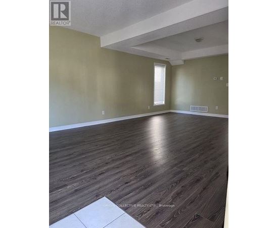 A room with wooden flooring and a window.