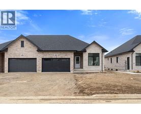 A real estate photo of a house with a garage.