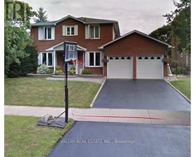 A house with a driveway and a sign that says Valery Real Estate Inc., Brokerage.