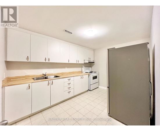 A kitchen with white cabinets and a sink.