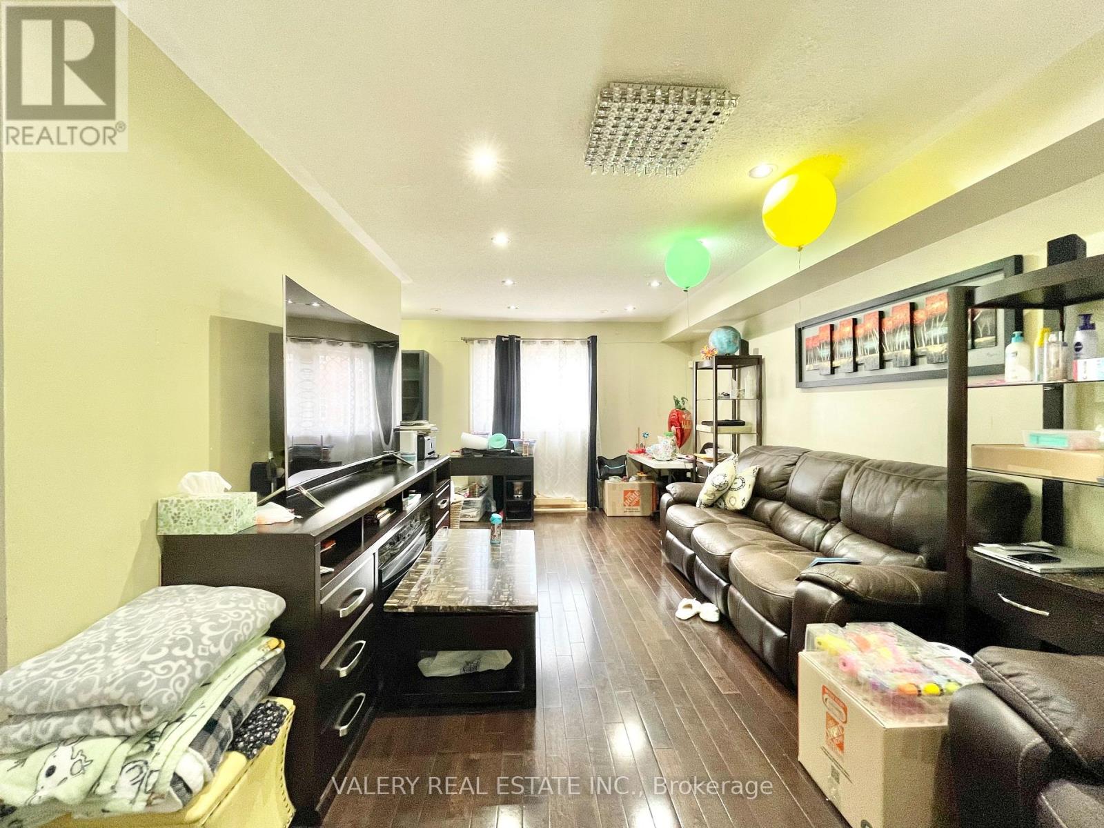 A living room with a couch, coffee table, and a TV.