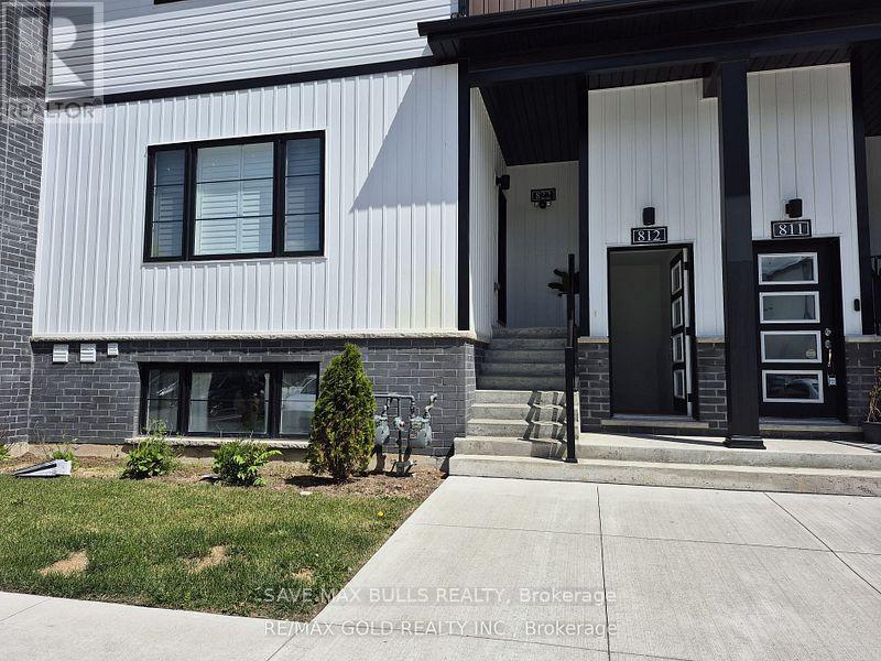 A modern house with a black and white exterior and a black front door.
