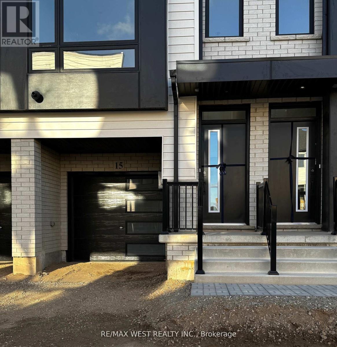 A modern house with a black front door and windows.