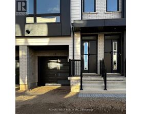 A modern house with a black front door and windows.