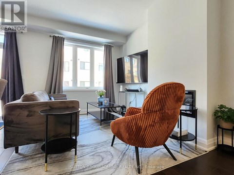 A living room with a brown chair and a grey sofa.