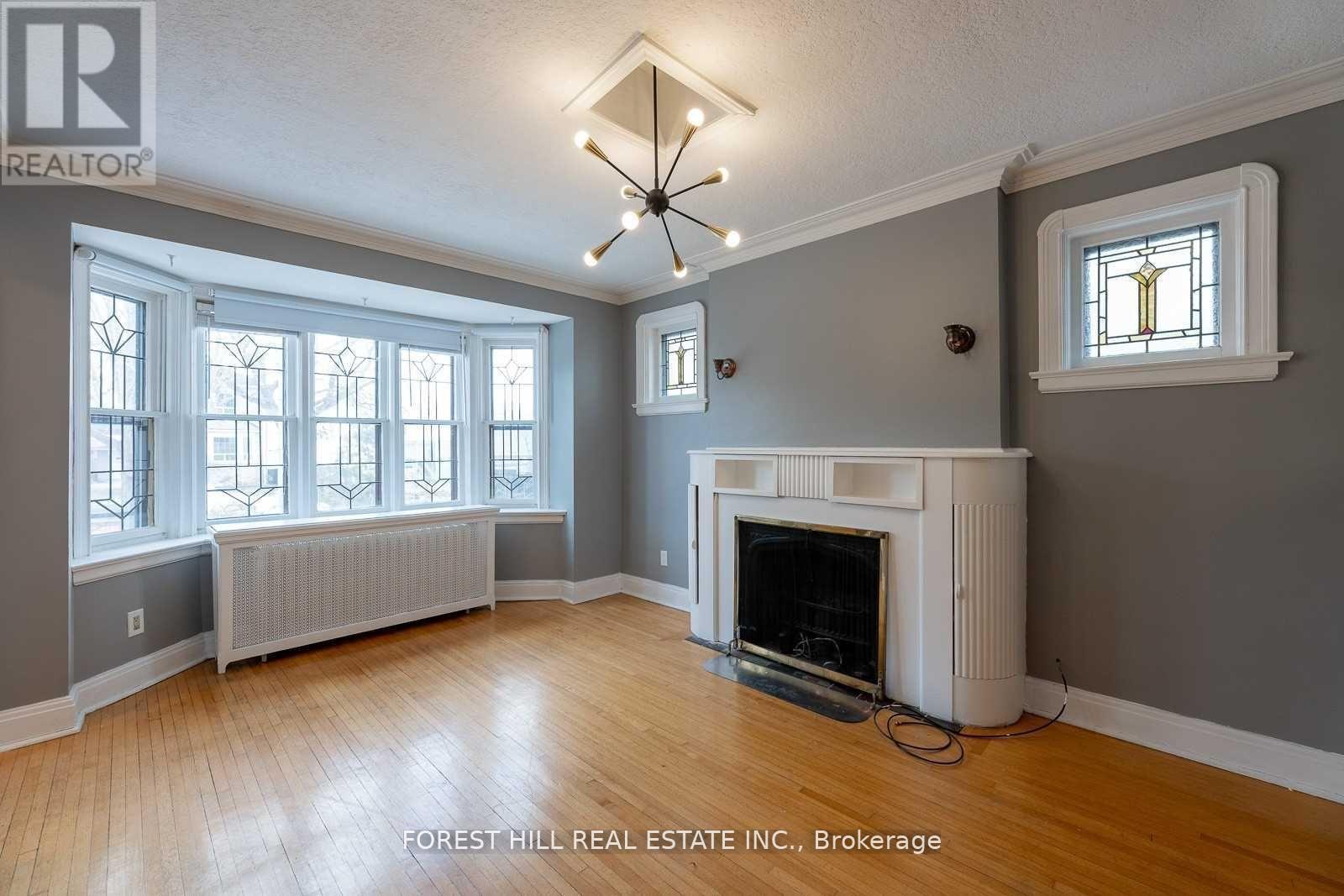 A living room with a fireplace and a chandelier.