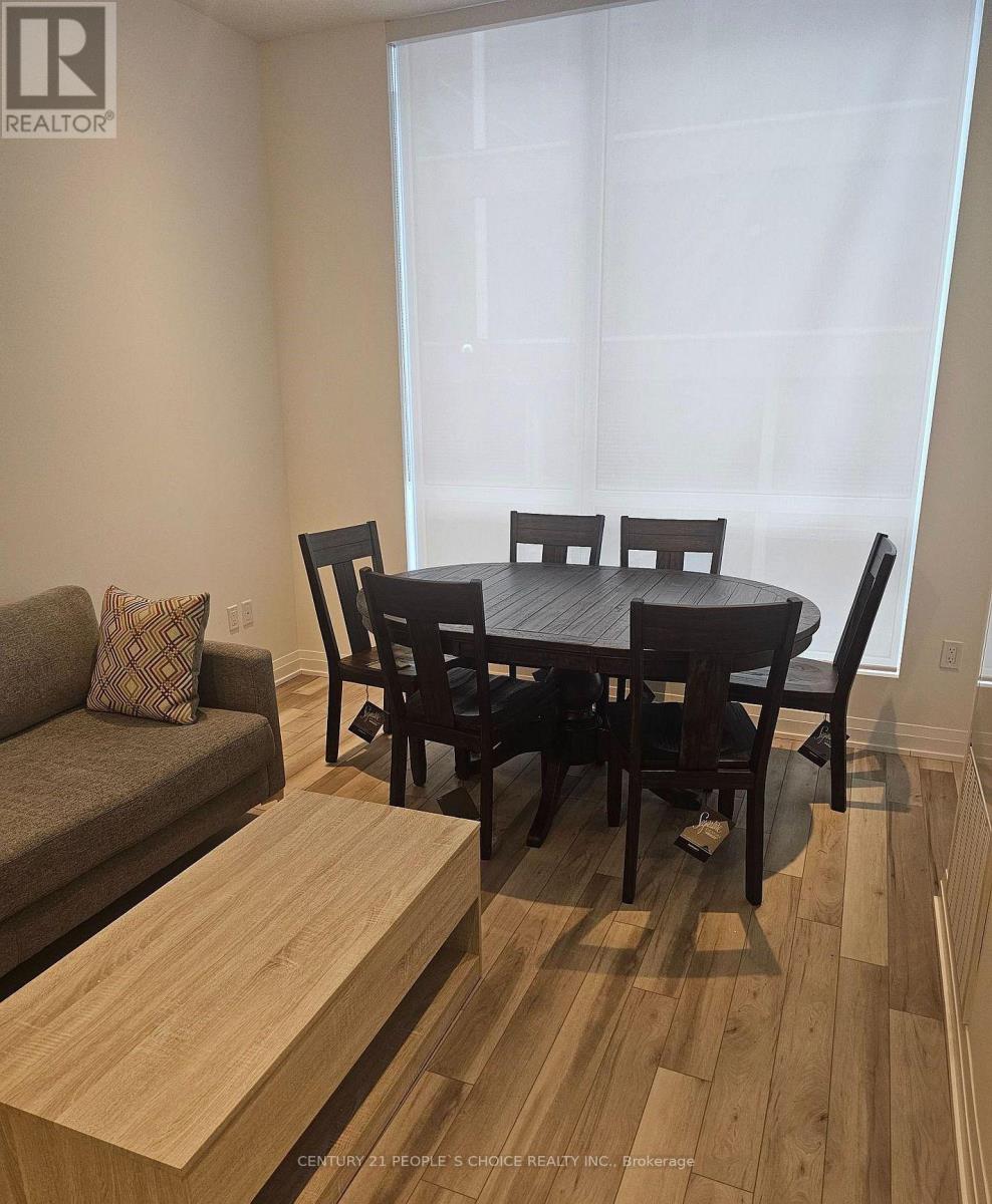 A dining room with a wooden table and chairs.