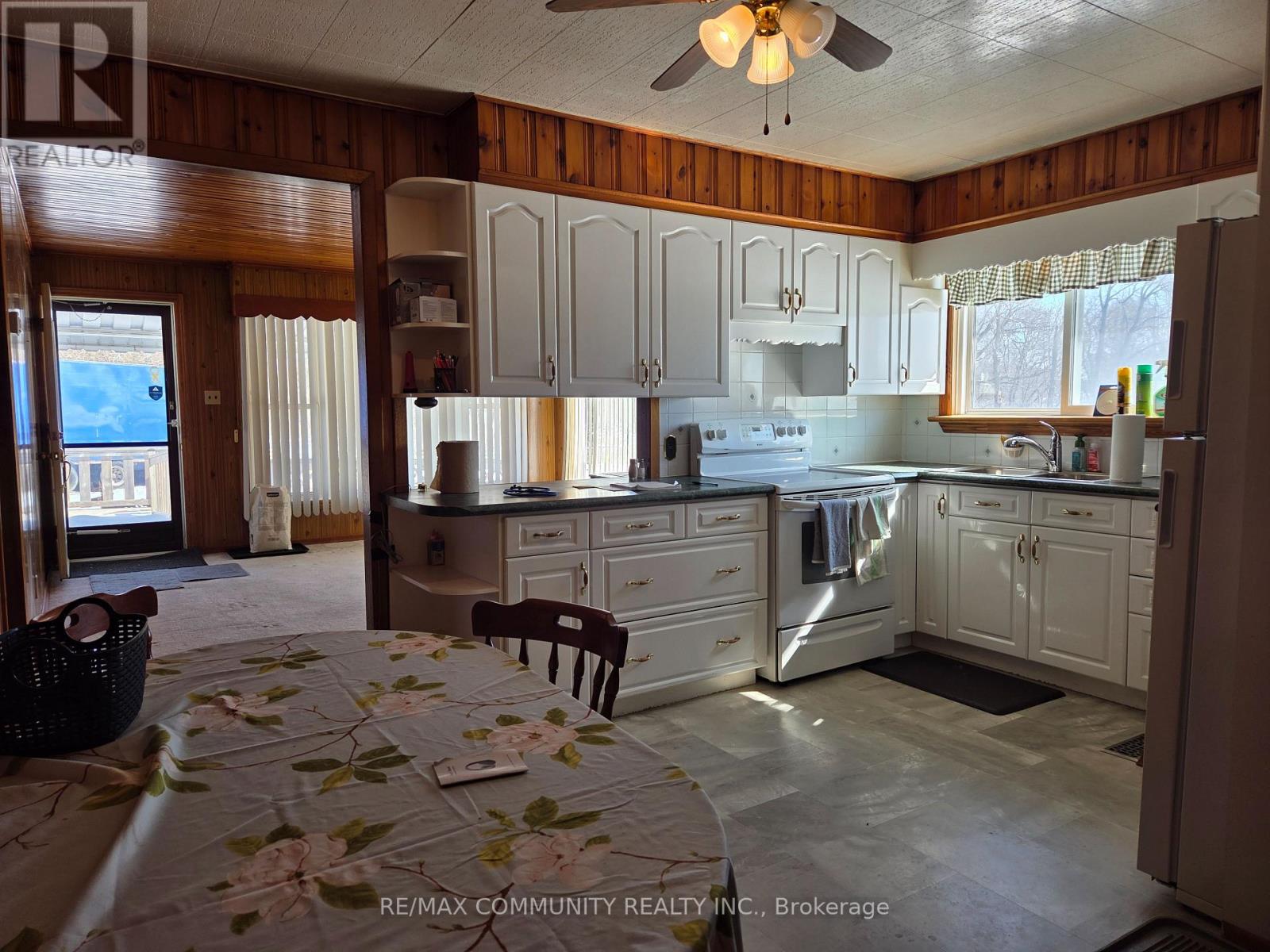 A kitchen with a table and chairs in it.