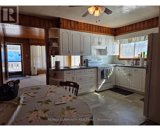 A kitchen with a table and chairs in it.