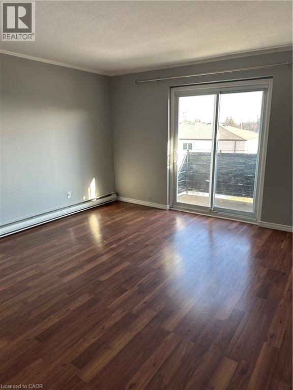 A room with wood flooring and two white closet doors.