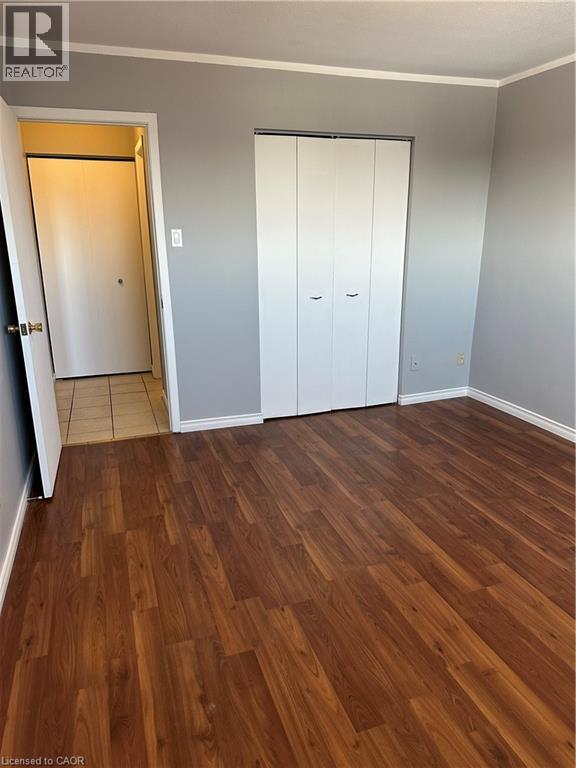 A room with wooden flooring and a window.