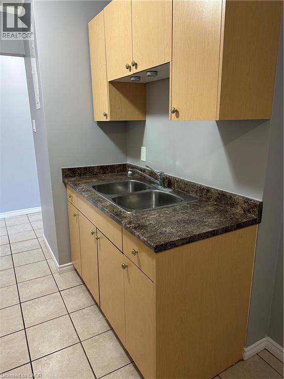 A kitchen with a sink and cabinets.