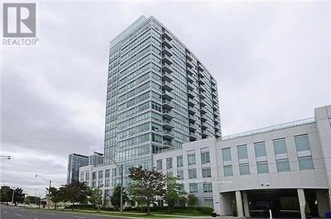 A tall glass building with a modern design is shown in the image.