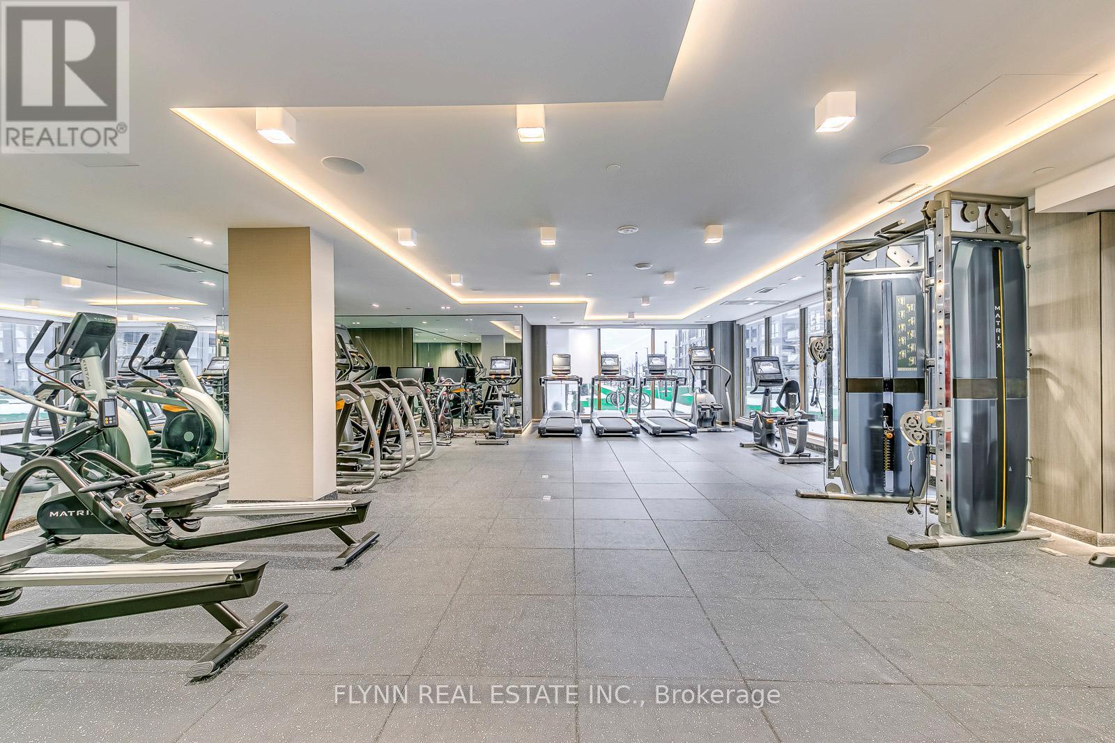 A gym with treadmills, elliptical machines, and other exercise equipment.