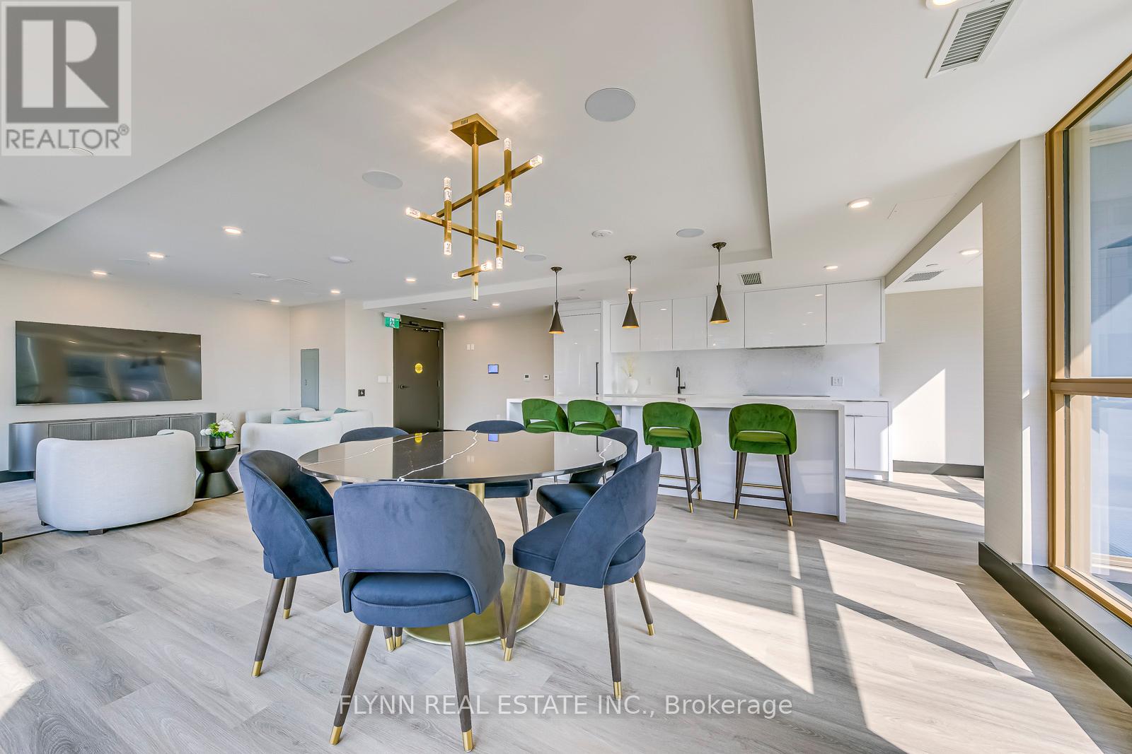 A modern dining room with a glass table and chairs.