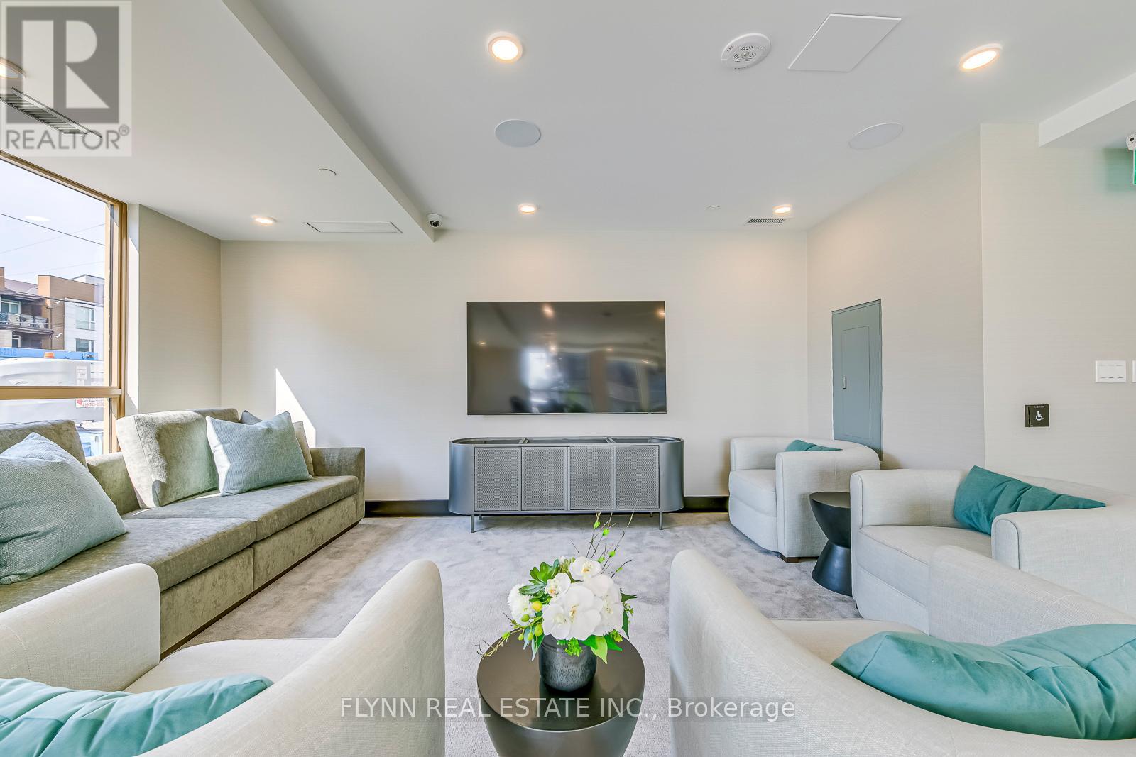 A living room with a grey sofa set and a television.