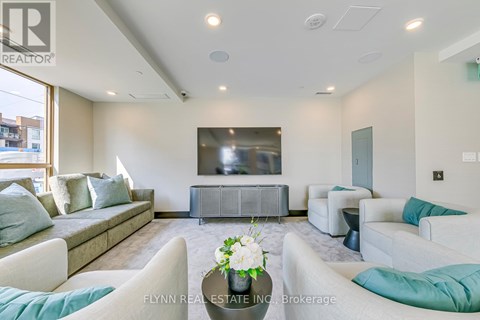 A living room with a grey sofa set and a television.