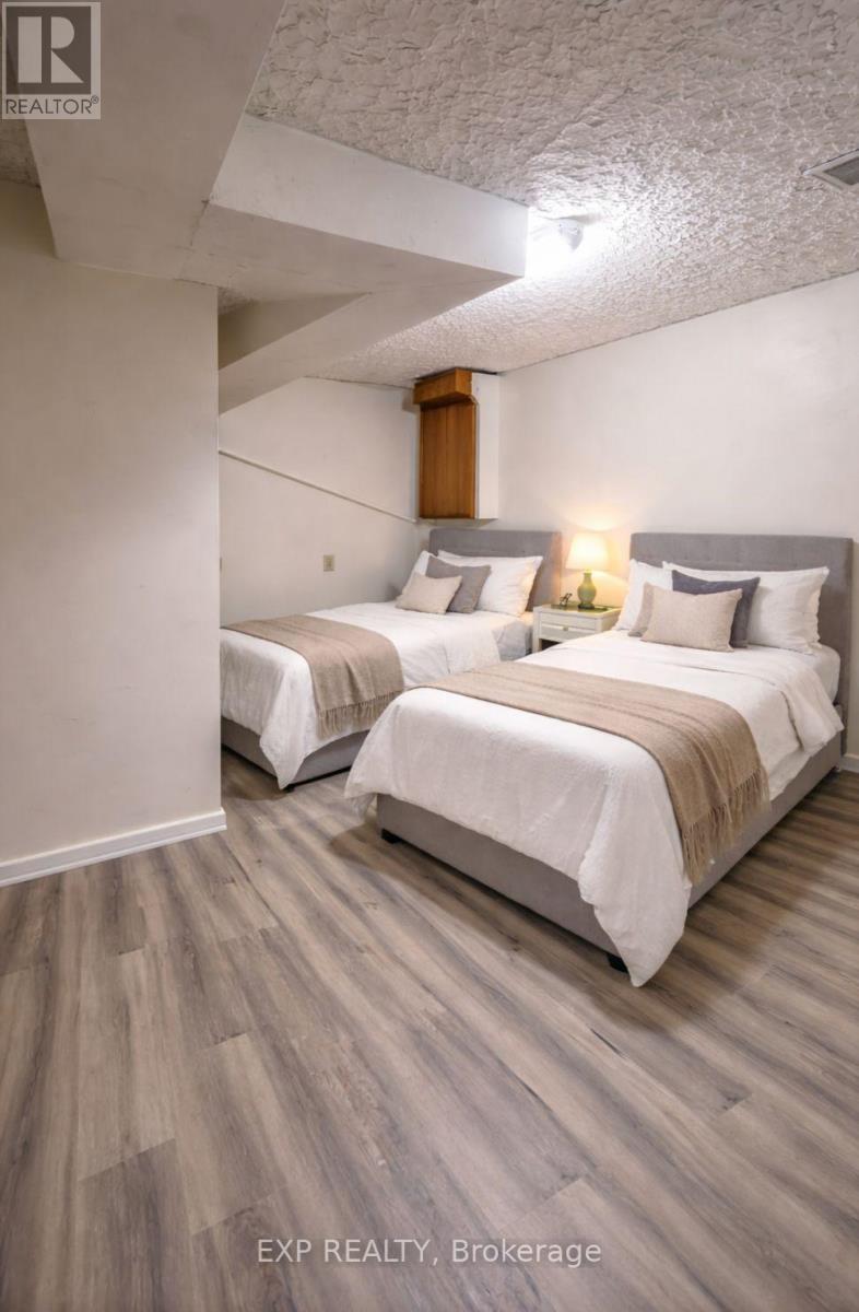 Two beds in a room with EXP Realty, Brokerage written on the bottom.