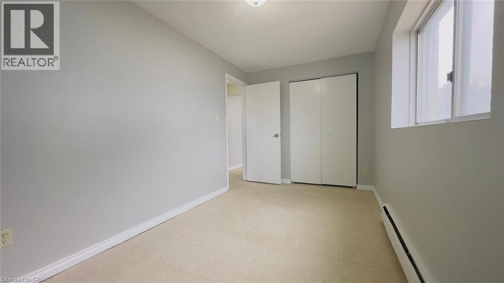 A white bedroom with a large closet and a window.