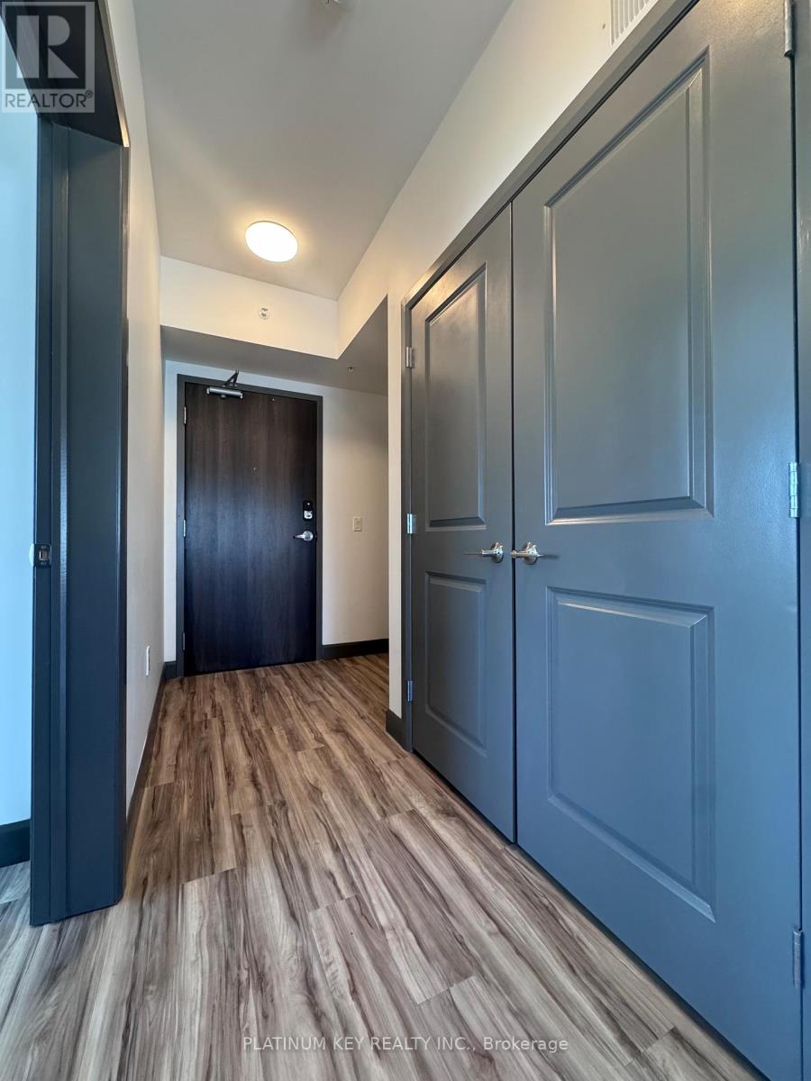 A hallway with wood flooring and blue doors.