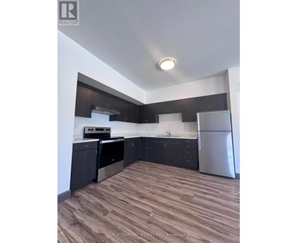 A kitchen with dark wood cabinets and stainless steel appliances.