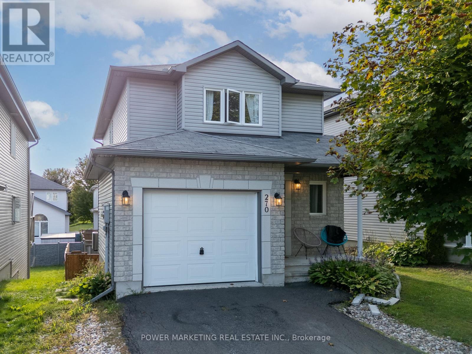 A house with a white garage door is for sale.