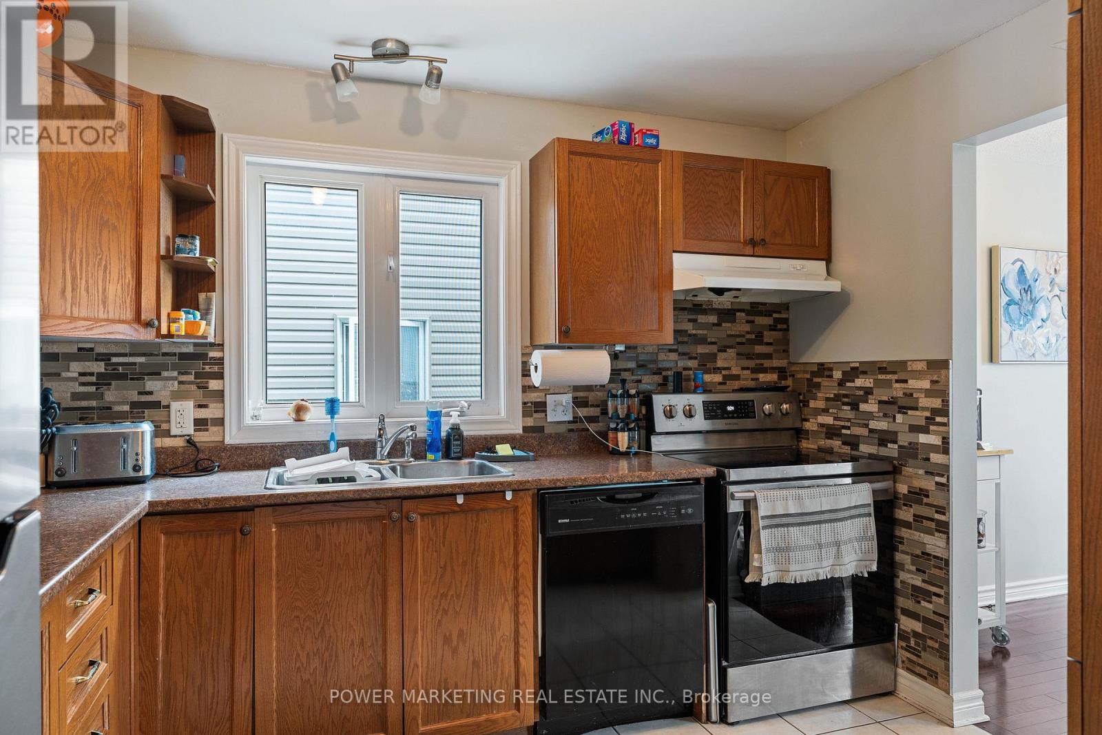 A kitchen with wooden cabinets and a black oven.