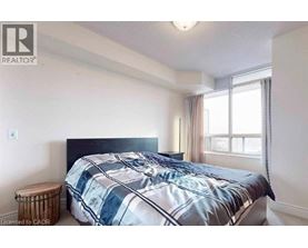 A bedroom with a bed and a window.