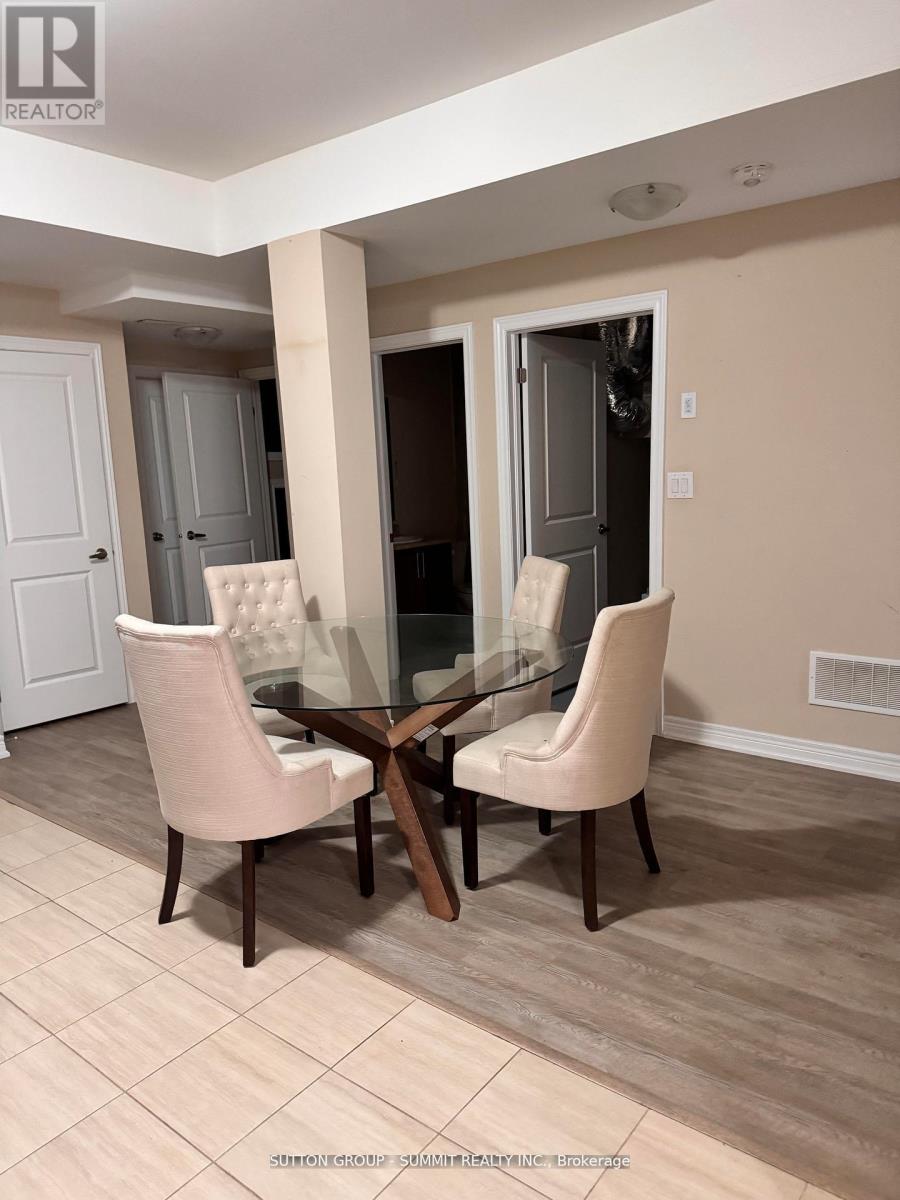 A dining room with a glass table and chairs.