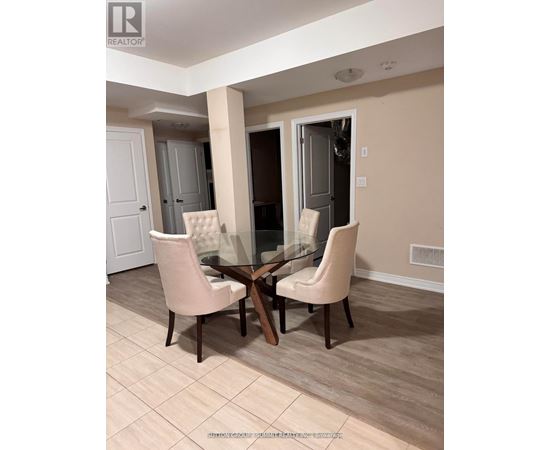 A dining room with a glass table and chairs.