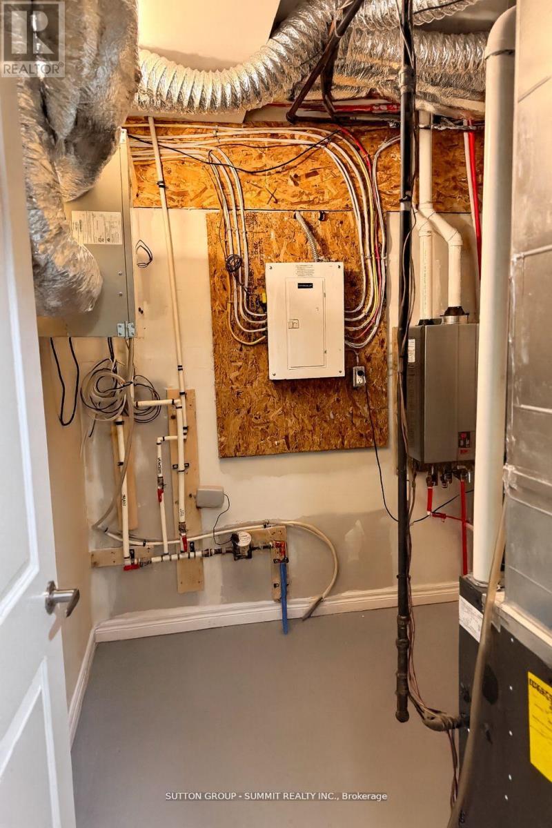 A wall of pipes and wires in a room.