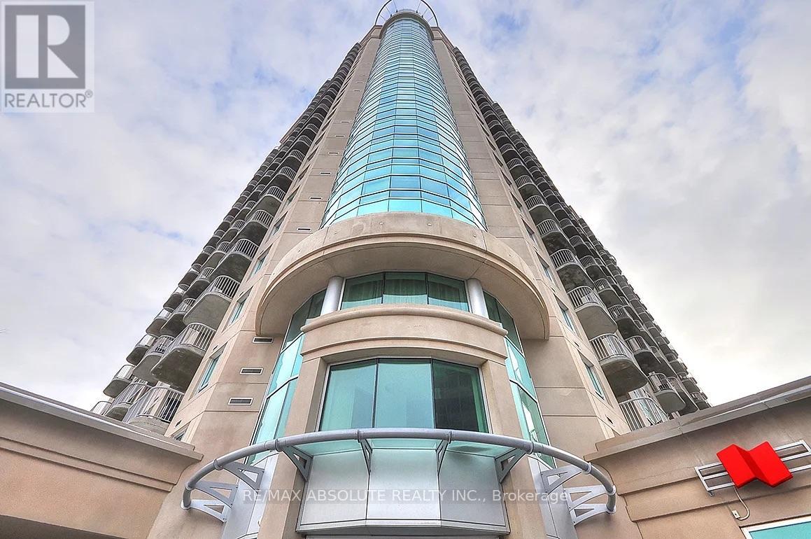 A tall building with a glass facade and a sign that reads "REMAX ABSOLUTE BEAUTY INC.".