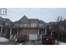 A house with a car parked in front of it.