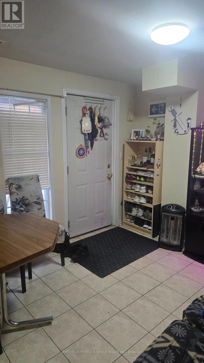 A room with a table and a door with a decorative plate on it.