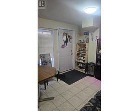 A room with a table and a door with a decorative plate on it.